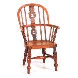 A MID 19TH CENTURY YEWWOOD CHILD'S WINDSOR CHAIR with hooped back, Christmas tree pierced splat