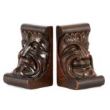 A PAIR OF LATE 19TH CENTURY CARVED OAK BOOKENDS modelled as two faces, Comedy/Tragedy 21cm high