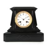 A SMALL LATE 19TH CENTURY BLACK MARBLE MANTEL CLOCK the angled case with engraved panels enclosing a