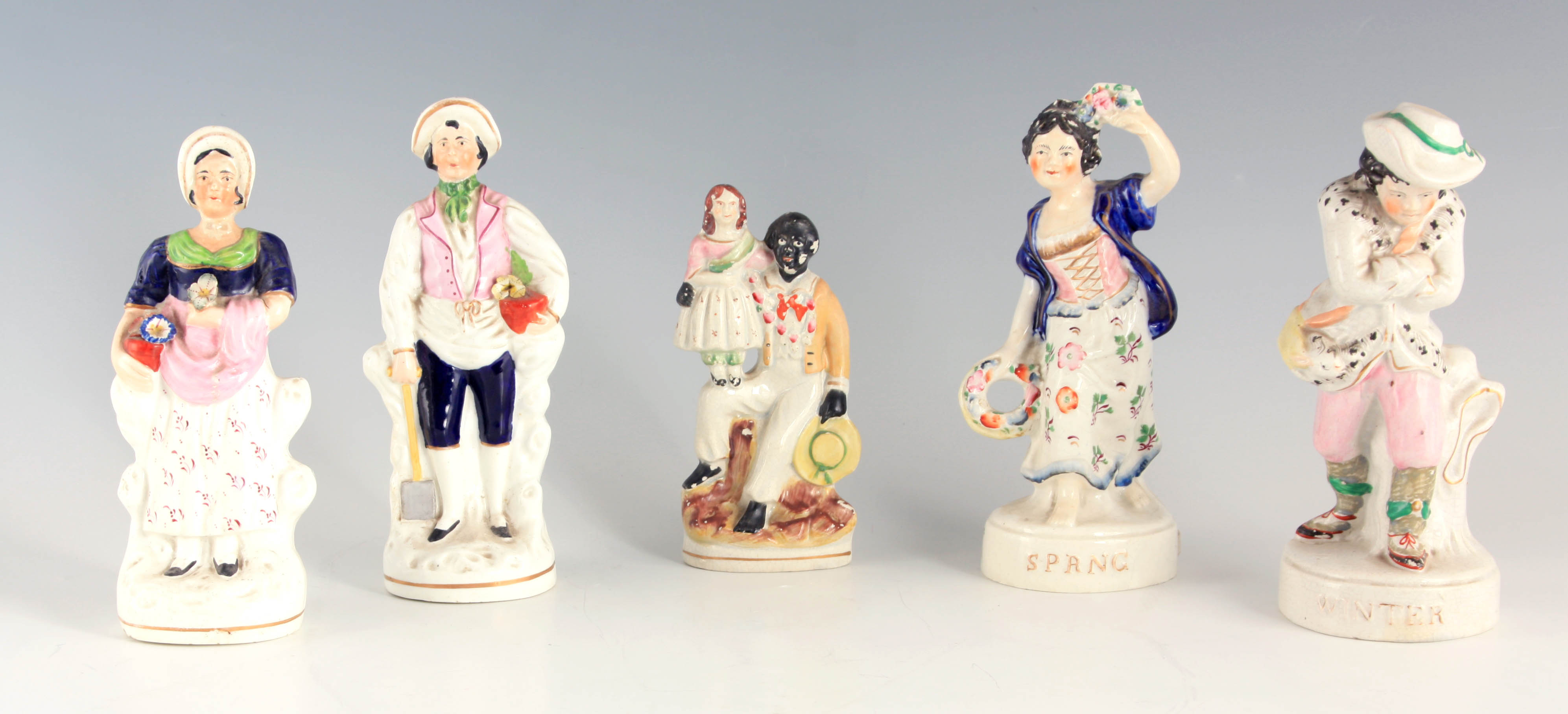 A PAIR OF 19TH CENTURY STANDING STAFFORDSHIRE FIGURES of Spring and Winter 21.5 and 21cm high