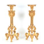 A PAIR OF GILT GESSO TORCHERES of rococo design with scrolled leaf work decoration and shellwork