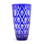 A BOHEMIAN BLUE OVERLAY AND CLEAR TAPERING GLASS VASE with lozenge decoration to the body
