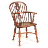 A 19TH CENTURY NOTTINGHAMSHIRE YEW WOOD WINDSOR ARM CHAIR with shaped fret cut "christmas tree"