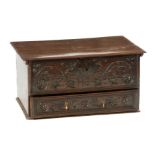 A 17TH CENTURY OAK MULE CHEST OF SMALL SIZE with hinged top above a floral carved front with