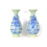 AN IMPRESSIVE PAIR OF 19TH CENTURY CHINESE CELADON AND RELIEF DECORATED BALUSTER VASES WITH INVERTED