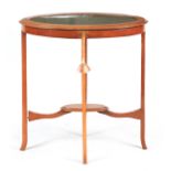 AN EDWARDIAN INLAID MAHOGANY OVAL SHAPED BIJOUTERIE TABLE with hinged top revealing a fitted