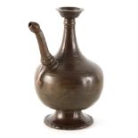 A 16TH CENTURY TIMURID PERSIAN BRONZE EWER of ribbed bulbous design with flared foot and tapering