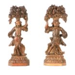 A PAIR OF LATE 16TH CENTURY LIME WOOD CARVINGS depicting figures holding fruit and flowers;