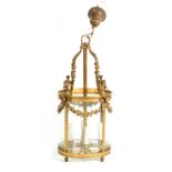 A FINE 19TH CENTURY REGENCY STYLE CAST BRASS HALL LANTERN of panelled cylindrical form with ribbon-