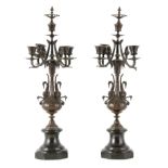 A PAIR OF LATE 19TH CENTURY PATINATED BRONZE AND BLACK MARBLE FOUR BRANCH CANDELABRA having lion's