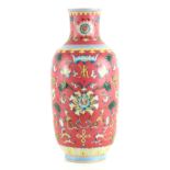 A CHINESE FAMILLE ROSE SLENDER OVOID SHOULDERED VASE with delicate all over flower spray