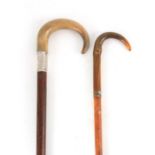 TWO LATE 19TH CENTURY RHINO HORN HANDLED WALKING STICKS one with mahogany shaft and silver collar