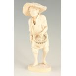 A GOOD 19TH CENTURY TOKYO SCHOOL CARVED IVORY STANDING FIGURE modelled as a farmer carrying a basket