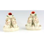 A PAIR OF STAFFORDSHIRE SPILL VASES each modelled as seated poodles dressed in encrusted head and