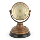 A LATE 19TH CENTURY BRASS BAROMETER/THERMOMETER DESK STAND the brass gimbaled case with magnified
