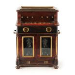 A UNUSUAL LATE 19TH CENTURY NOVELTY MUSICAL LIQUEUR TANTALUS with hinged glazed top enclosing a