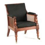 A REGENCY MAHOGANY BERGERE LIBRARY CHAIR OF GENEROUS PROPORTIONS IN THE MANNER OF GILLOWS the fluted