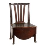AN EARLY 18TH CENTURY OAK SHIPS COMMODE CHAIR OF LARGE SIZE with fanned splat back and iron hinged