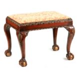 A GEORGE I STYLE WALNUT AND GILT DECORATED STOOL with leaf moulded seat rails above cabriole legs