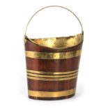 A GEORGE III BRASS BOUND MAHOGANY OYSTER PAIL of oval tapering coopered form with brass liner and