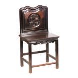 AN 18TH CENTURY CHINESE HARDWOOD SINGLE CHAIR with circular carved panel to the back depicting
