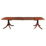 A FINELY FIGURED LATE GEORGIAN MAHOGANY EXTENDING DINING TABLE on later Regency style pedestal