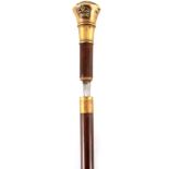 A NORTHERN NIGERIAN 5TH CLASS CHIEF MILITARY SWORD STICK with applied Heraldic emblem on tapering