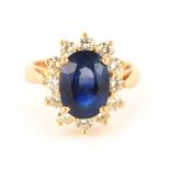 A LADIES 18CT YELLOW GOLD SAPPHIRE AND DIAMOND RING the 3.00ct centre sapphire surrounded by 12