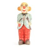 A CARVED PAINTED WOOD SCULPTURE OF A CLOWN decorated in polychrome colours 60cm high