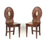 A PAIR OF LATE 18TH CENTURY ADAM STYLE MAHOGANY HALL CHAIRS with oval shell carved backs and
