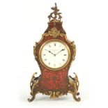 AN EDWARDIAN BOULLE AND TORTOISESHELL BALLOON SHAPED MANTEL CLOCK with brass mounts enclosing an