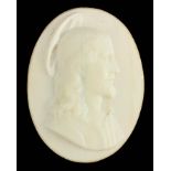 AN EARLY CARVED OPAQUE GLASS OVAL PORTRAIT OF CHRIST 8cm high 6cm wide