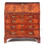 AN EARLY 18TH CENTURY FIGURED WALNUT BUREAU with herringbone inlay, the angled fall opening to