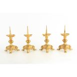 A SET OF FOUR 19TH CENTURY GILT BRONZE PRICKET STICKS cast with stylised animals and knopped stems