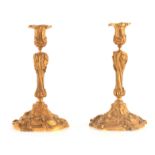 A PAIR OF 18TH CENTURY STYLE FRENCH ROCOCO GILT BRASS CANDLESTICKS with leaf work decoration and