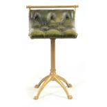 A 19TH CENTURY BRASS AND BUTTONED LEATHER MUSIC STOOL possibly for harp or cello, with brass bar