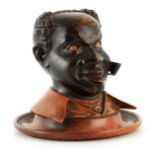 A 19TH CENTURY CARVED WOOD TOBACCO JAR modelled as an African gentleman smoking a pipe, with
