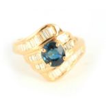 A LADIES 18CT YELLOW GOLD SAPPHIRE AND DIAMOND RING the brilliant-cut sapphire set over four bands