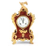 A LATE 19TH CENTURY FRENCH TORTOISESHELL AND ORMOLU MOUNTED MANTEL CLOCK the shaped case having