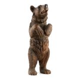 A GOOD QUALITY LATE 19TH CENTURY BLACK FOREST STANDING BEAR with glass eyes and an open mouth