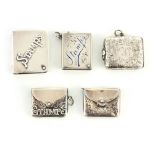 A COLLECTION OF FIVE SILVER STAMP BOXES two formed as books, two satchel-style boxes and one foliate