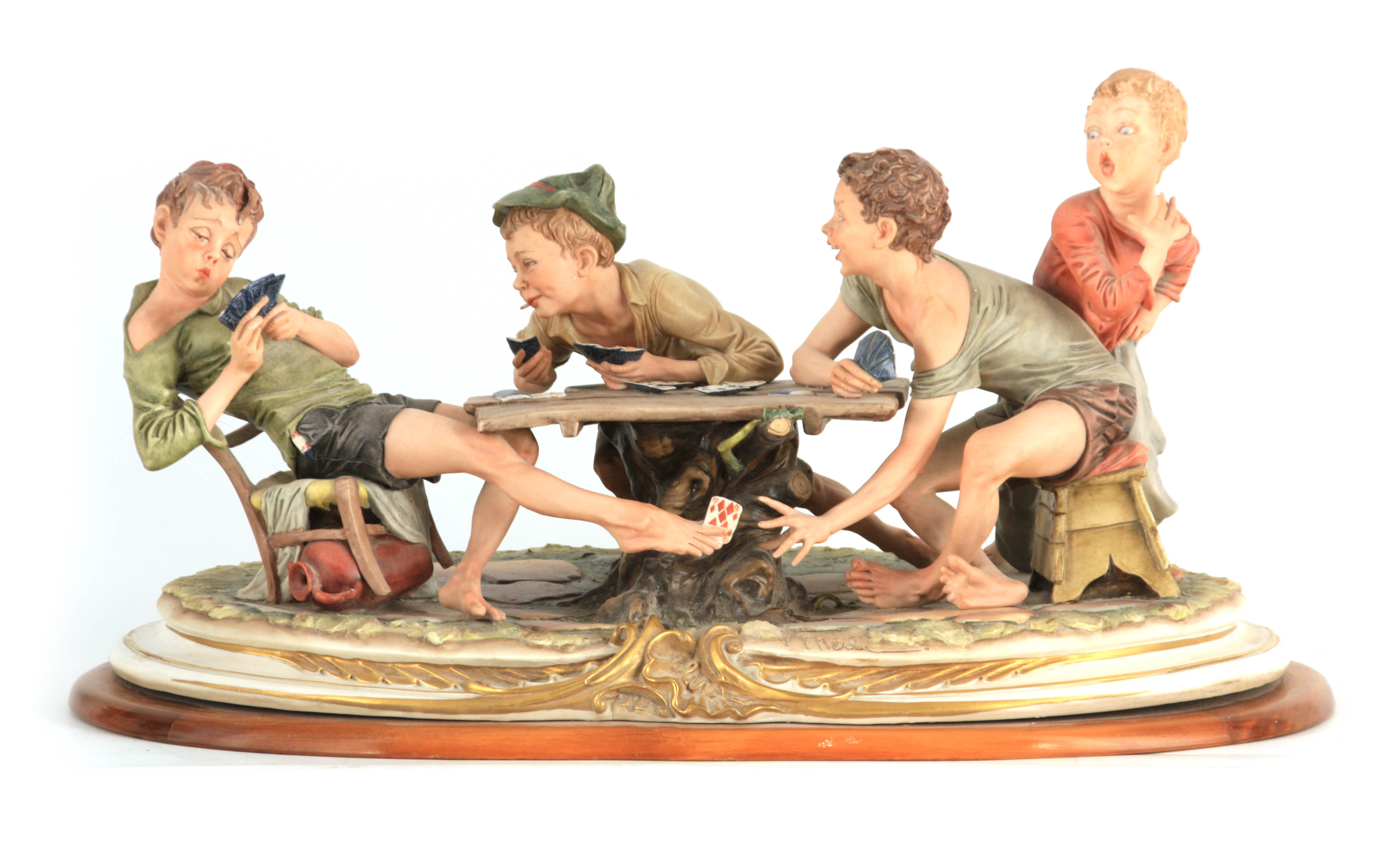 A NAPLES CAPODIMONTE LARGE OVAL FIGURE GROUP “The young card players” signed to base 56.5cm wide