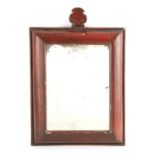 AN EARLY CONTINENTAL RED LACQUER CUSHION FRAMED MIRROR with crown-shaped pediment, the back carved