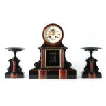 A LATE 19TH CENTURY FRENCH BLACK AND ROUGE MARBLE MANTEL CLOCK the arched top case with drum-