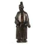 A LARGE MEIJI PERIOD JAPANESE PATINATED BRONZE FIGURE modelled as a sage mounted on a later