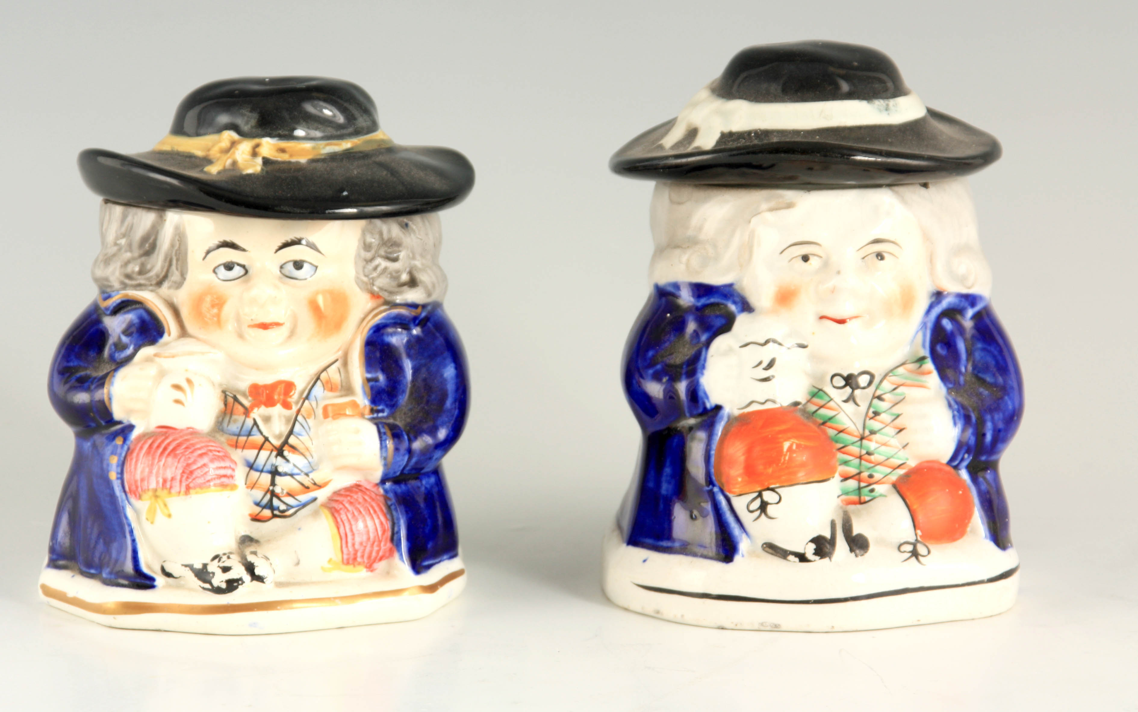 A PAIR OF COLOURFUL SEATED TOBY FIGURE LIDDED JARS 12.5cm high