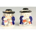 A PAIR OF COLOURFUL SEATED TOBY FIGURE LIDDED JARS 12.5cm high