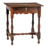 A LATE 17TH CENTURY OAK SIDE TABLE OF SMALL SIZE with moulded edge top above a frieze drawer and