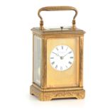 A LATE 19TH CENTURY FRENCH MASK DIAL ENGRAVED GILT BRASS REPEATING CARRIAGE CLOCK the full floral
