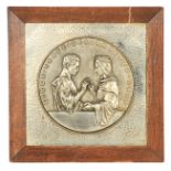 AN ARTS AND CRAFTS SILVERED BRONZE WALL PLAQUE entitled 'EINER TRAGE DES ANDEREN LAST' (BEAR YE